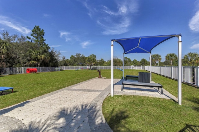 view of home's community with a patio, a lawn, and fence