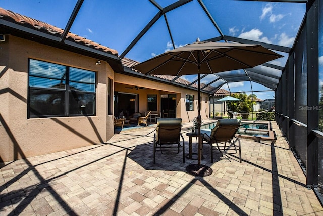 view of patio / terrace featuring ceiling fan, a lanai, and a pool with connected hot tub