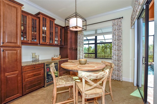 dining space featuring wine cooler, a dry bar, crown molding, and baseboards