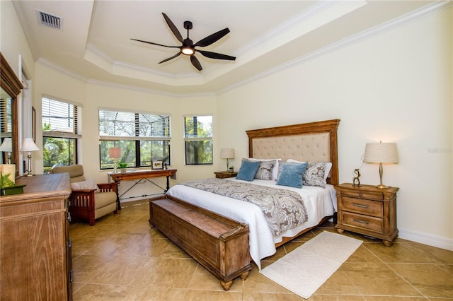 bedroom with a raised ceiling, light tile patterned floors, visible vents, and ornamental molding