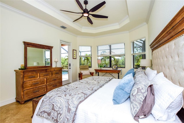 bedroom featuring a tray ceiling, multiple windows, visible vents, and ornamental molding