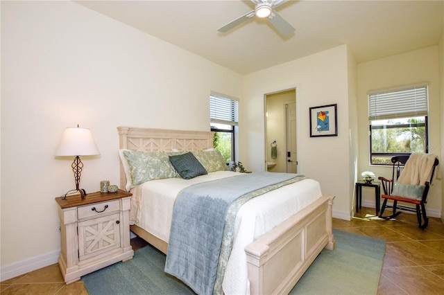 bedroom with connected bathroom, baseboards, ceiling fan, and tile patterned flooring