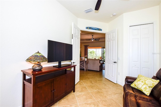 interior space featuring light tile patterned flooring, visible vents, baseboards, and a ceiling fan