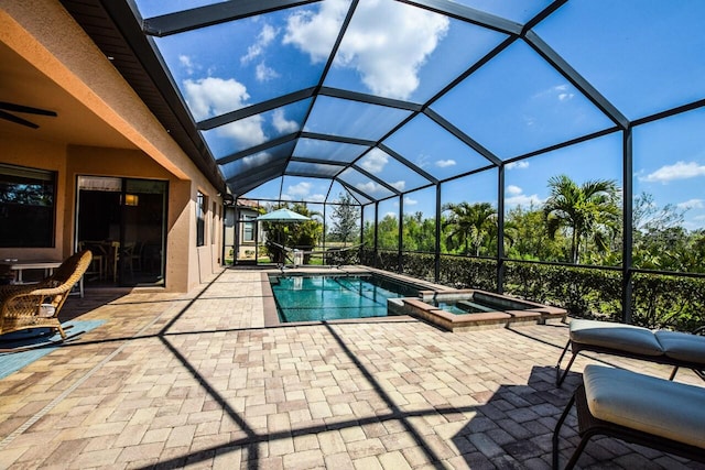 view of swimming pool with a lanai, a patio, ceiling fan, and a pool with connected hot tub