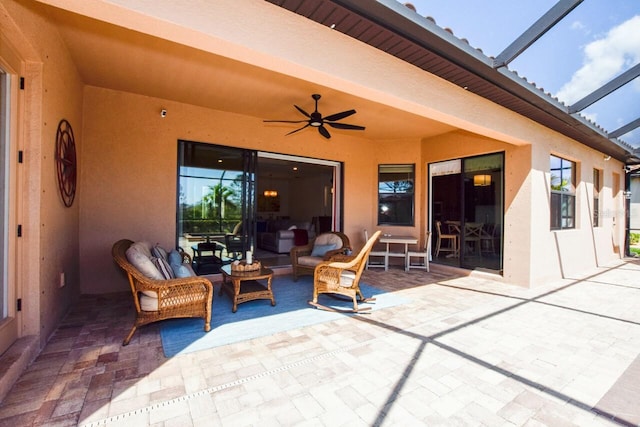 view of patio with glass enclosure and a ceiling fan