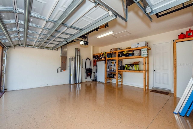 garage with electric panel and a garage door opener