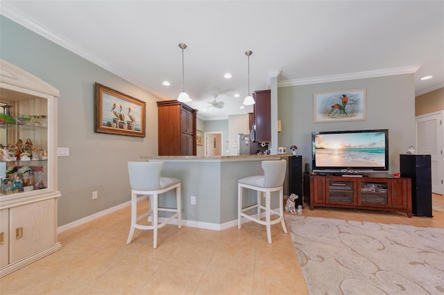 kitchen with light tile patterned floors, a peninsula, a kitchen breakfast bar, decorative light fixtures, and crown molding