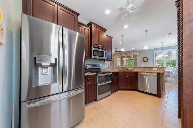 kitchen with appliances with stainless steel finishes, a ceiling fan, light tile patterned flooring, light stone countertops, and a peninsula