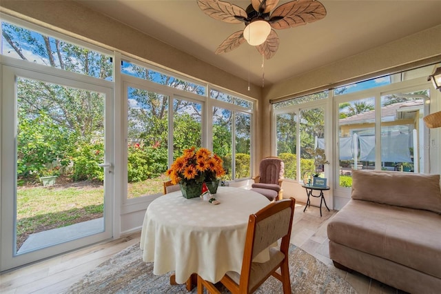 sunroom featuring a ceiling fan and a healthy amount of sunlight