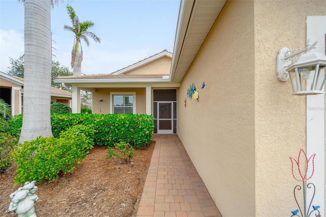 property entrance with stucco siding