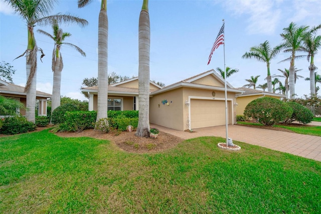 single story home featuring a garage, a front lawn, decorative driveway, and stucco siding