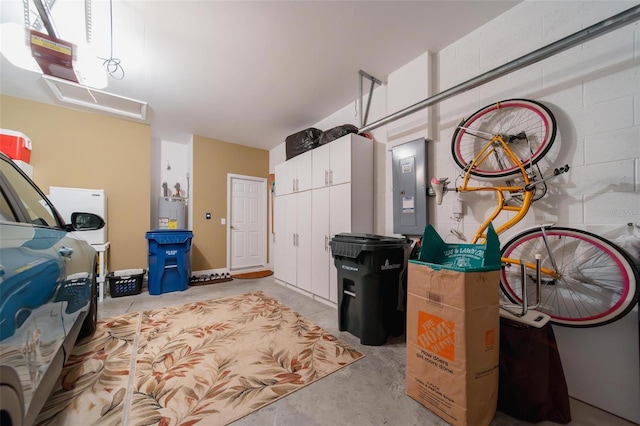 garage with water heater, electric panel, and a garage door opener