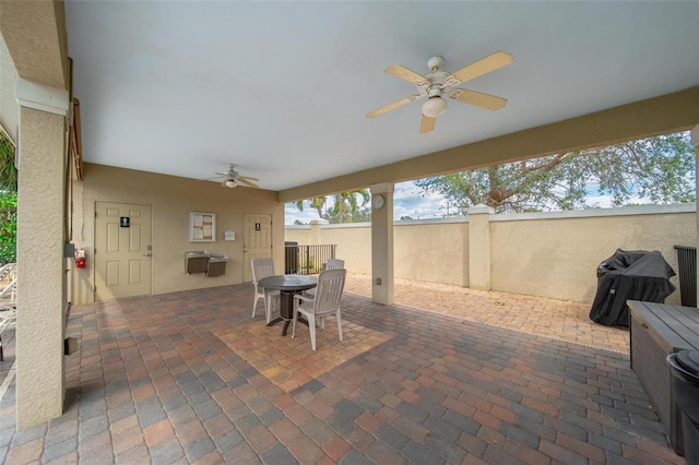 view of patio / terrace featuring ceiling fan, fence, a grill, and outdoor dining space