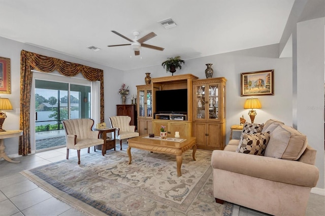 living room with visible vents, a ceiling fan, and light tile patterned flooring