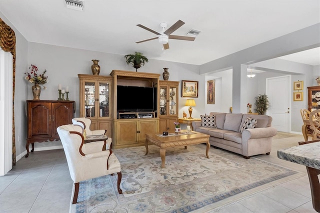 living room with a ceiling fan, visible vents, and light tile patterned flooring