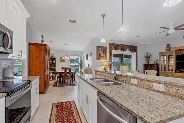 kitchen featuring light tile patterned floors, a sink, visible vents, white cabinets, and appliances with stainless steel finishes