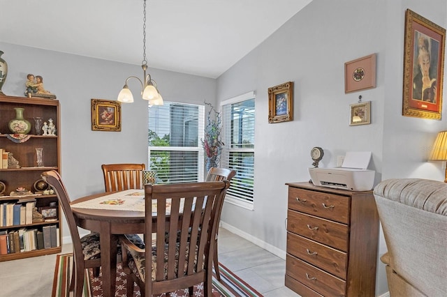 dining room with light tile patterned floors, baseboards, vaulted ceiling, and a notable chandelier