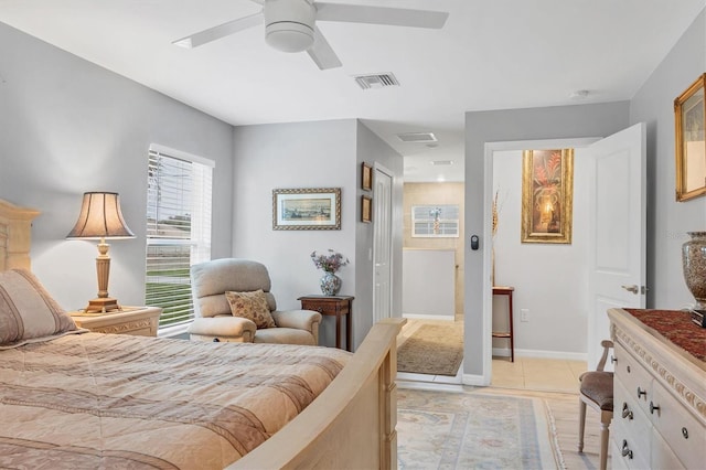 bedroom with baseboards, visible vents, a ceiling fan, and light tile patterned flooring