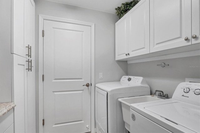 laundry area featuring washer and dryer and cabinet space