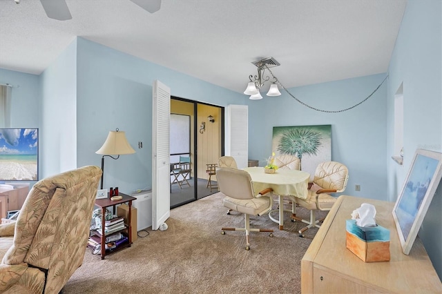 dining space featuring carpet floors, visible vents, and ceiling fan with notable chandelier