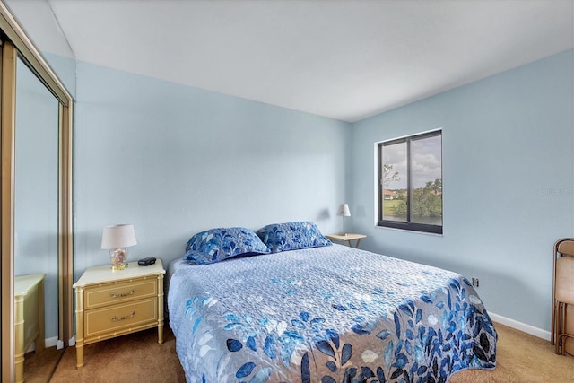 carpeted bedroom featuring baseboards