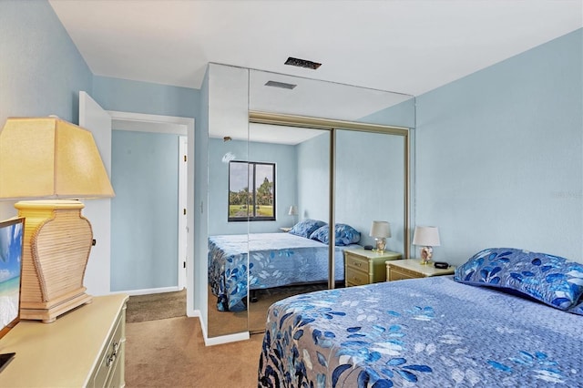 carpeted bedroom with a closet and visible vents