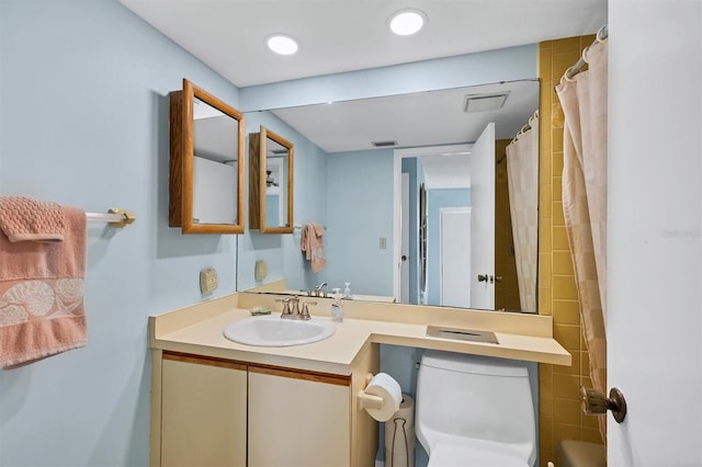 bathroom with recessed lighting, visible vents, vanity, and toilet