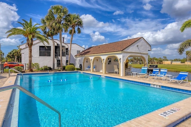 pool with a patio area and a gazebo