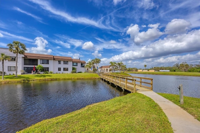 dock area featuring a water view and a yard