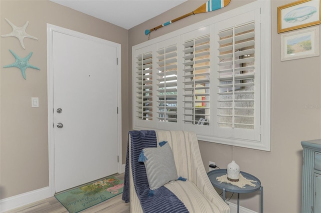 interior space with baseboards and wood finished floors