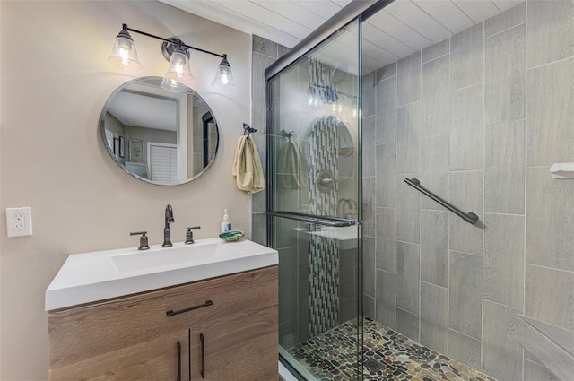 full bath with a shower stall and vanity