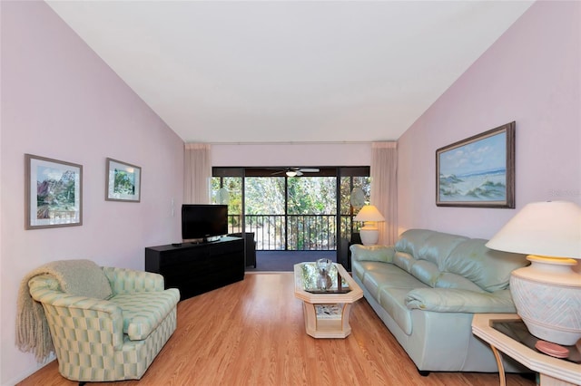 living area with vaulted ceiling, ceiling fan, and wood finished floors