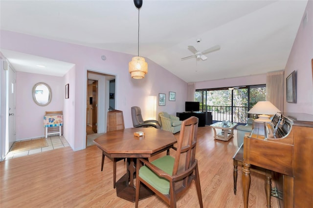 dining area with lofted ceiling, a ceiling fan, and light wood-style floors