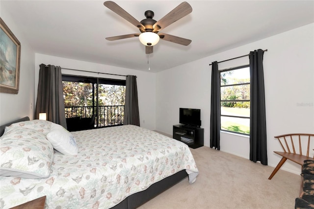 bedroom featuring access to exterior, ceiling fan, and light colored carpet