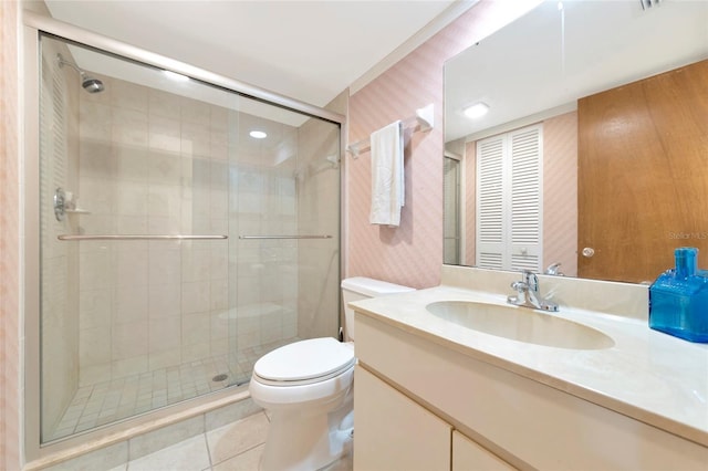 full bath featuring vanity, a shower stall, toilet, and wallpapered walls