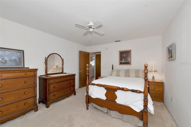 bedroom featuring ceiling fan, visible vents, and light colored carpet