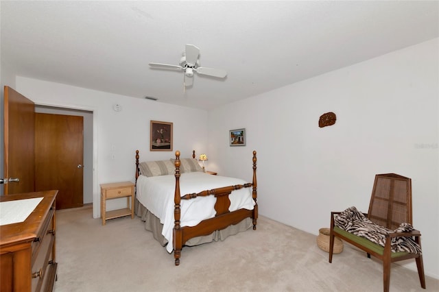 bedroom featuring ceiling fan, visible vents, and light colored carpet