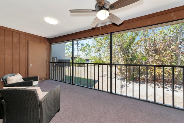 sunroom / solarium with a ceiling fan