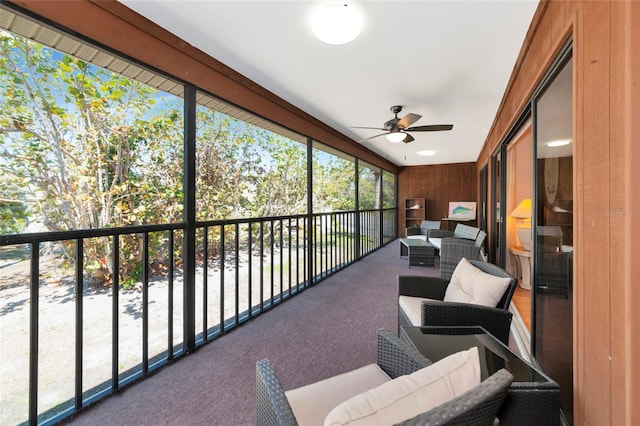 sunroom featuring a ceiling fan