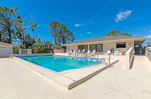 pool featuring a patio area and fence