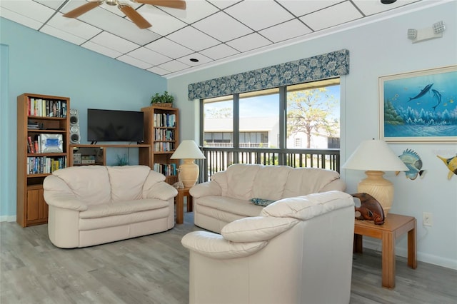 living room featuring light wood finished floors, ceiling fan, and baseboards