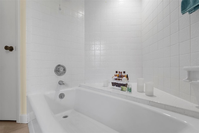 full bath featuring tile patterned flooring and a bath