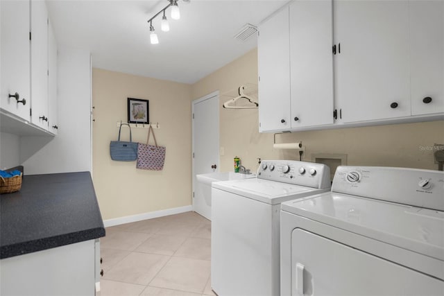 washroom featuring independent washer and dryer, baseboards, light tile patterned flooring, visible vents, and cabinet space