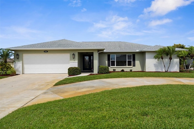 ranch-style home featuring a front yard, stucco siding, driveway, and a garage