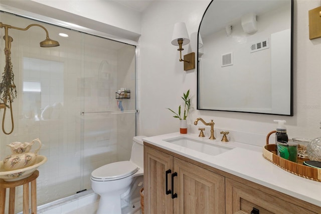 full bathroom with toilet, vanity, a shower stall, and visible vents