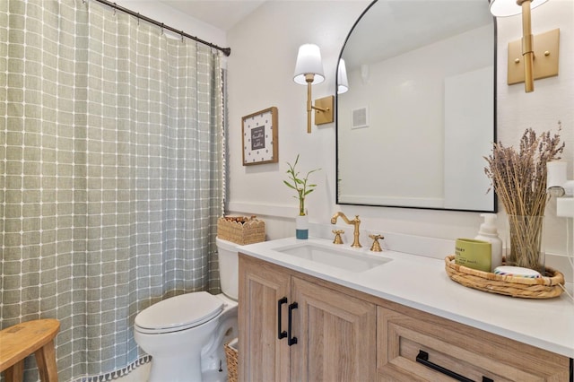 bathroom featuring toilet, a shower with shower curtain, vanity, and visible vents