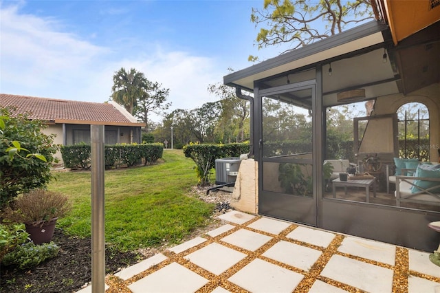 view of patio with cooling unit and a sunroom