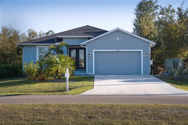 view of front of property featuring stucco siding, a garage, concrete driveway, and a front lawn