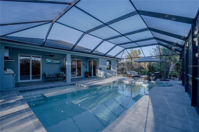 pool with a ceiling fan, a lanai, and a patio area