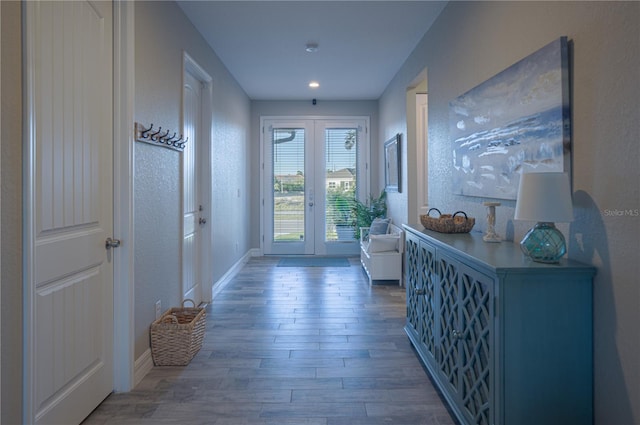 entryway with french doors, baseboards, and wood finished floors